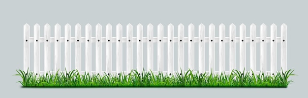 White wooden picket fence with green grass