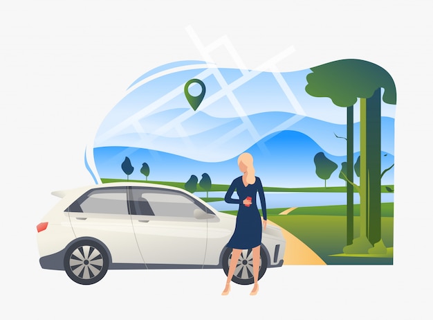 Woman standing by car with landscape in background