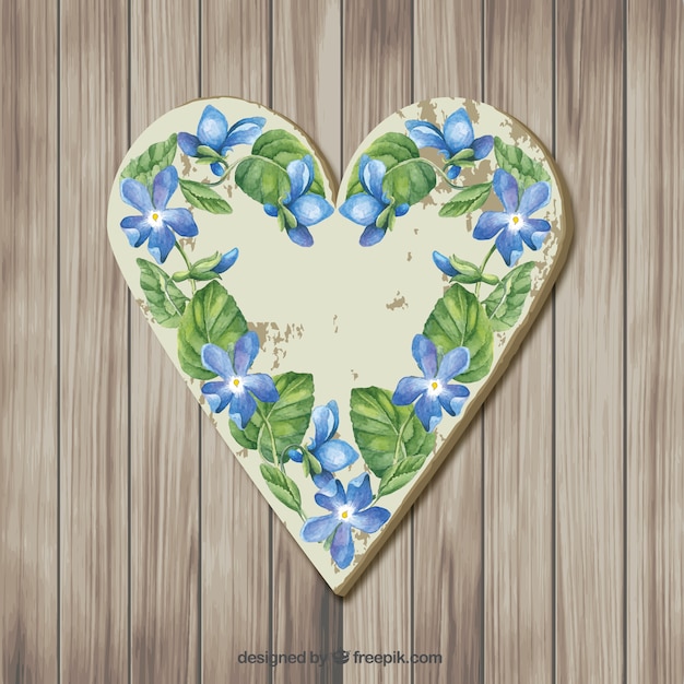 Free vector wooden heart with flowers