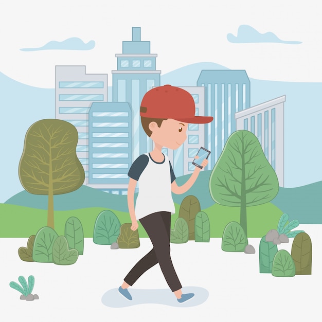 Young boy walking using smartphone in the park