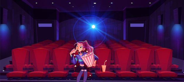 Young woman in cinema mesmerized girl with pop corn bucket in hands sitting alone in movie theater