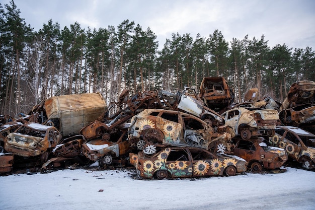 03022023 Irpin Ukraine Stacked a bunch of crashed cars after fire and missiles attacks in town with art on them