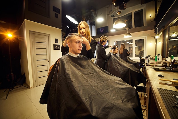 09 of February 2021 Vinnitsa Ukraine Salon Man in a barber chair The hairdresser serves the client in the barbershop The concept of male cosmetology