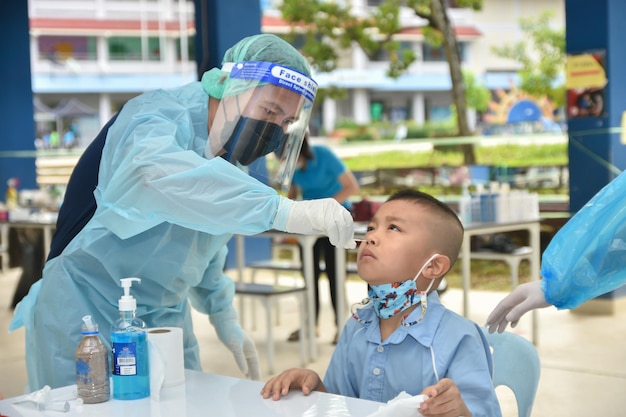 10 Nov 2021; Chiang Rai, Thailand:Teachers use rapid self-testing antigen kits. (atk)Covid-19 test for students