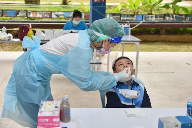 10 Nov 2021; Chiang Rai, Thailand:Teachers use rapid self-testing antigen kits. (atk)Covid-19 test for students