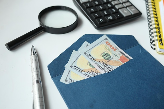 100 dollar cash in a envelope on a desk