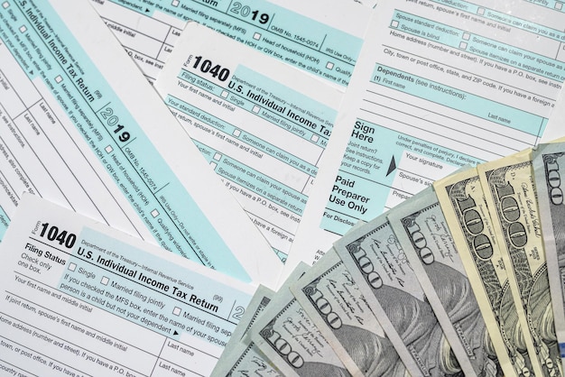 1040 individual income tax return with dollar on table Tax time Financial document