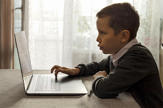 A 10yearold boy learns mental math with a laptop and abacus