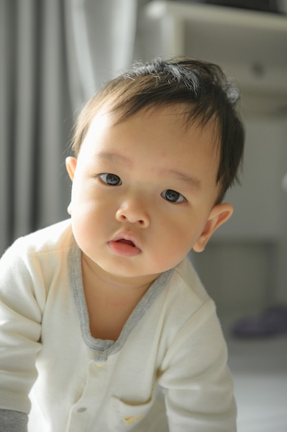 11 months baby boy portrait, asian kid face, little boy smiling