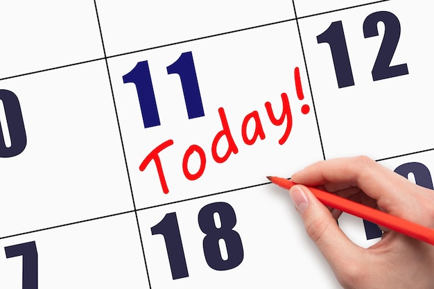 11th day of the month Hand writing text TODAY on calendar date Save the date