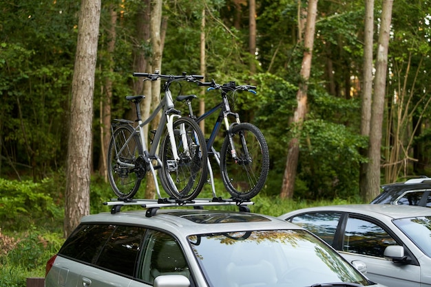 14082023 Poland Europe Passenger car with two bicycles mounted to the roof Concept of sport and outdoor family vacation