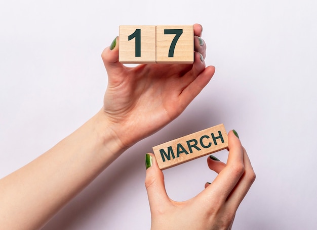 17 march inscription on wooden calendar in female hands.