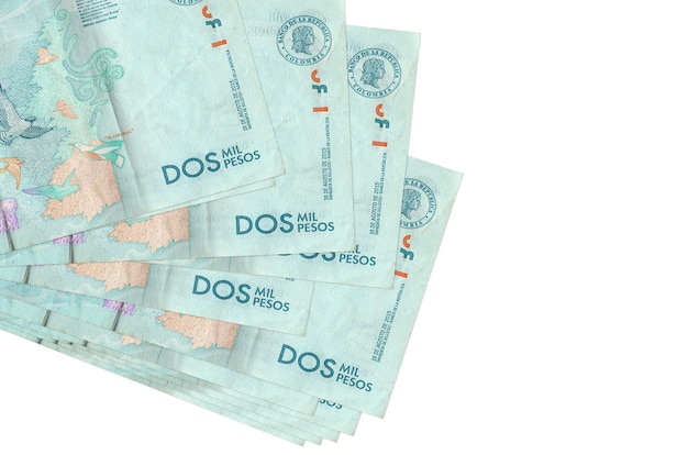 2 Colombian pesos bills lies in small bunch or pack isolated on white.  Business and currency exchange concept