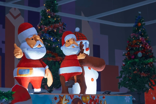 2 Santa Claus dolls and Christmas decorations display with lighting in shopping mall area