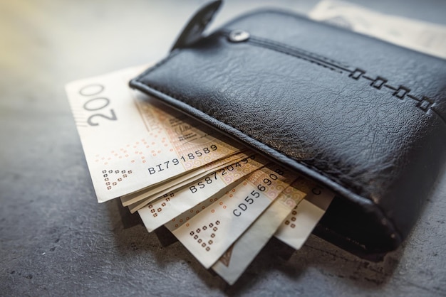 200 100 zloty banknotes in a black male wallet