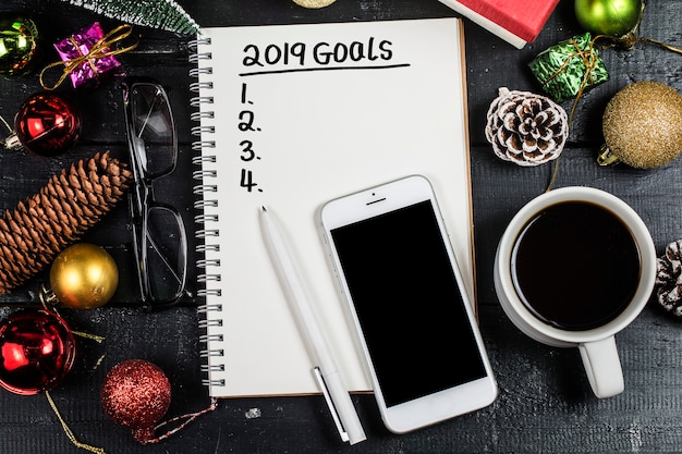 Photo 2019 new year goal,plan,action text on notepad with office accessories.