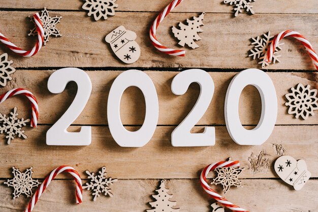 2020 New year concept on wood table and christmas decoration background.