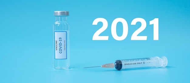 2021 happy New Year with COVID-19 Vaccine vial and injection Needle Syringe