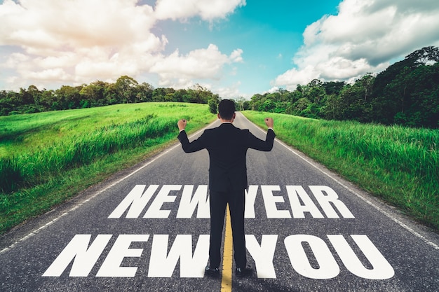 The 2021 New Year journey and future vision concept . Businessman traveling on highway road leading forward to happy new year celebration in beginning of 2021 for fresh and successful start .