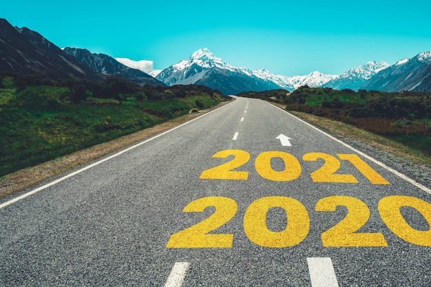 2021 New Year road trip travel and future vision concept . Nature landscape with highway road leading forward to happy new year celebration in the beginning of 2021 for fresh and successful start .