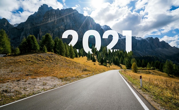 2021 New Year road trip travel and future vision concept . Nature landscape with highway road leading forward to happy new year celebration in the beginning of 2021 for fresh and successful start .