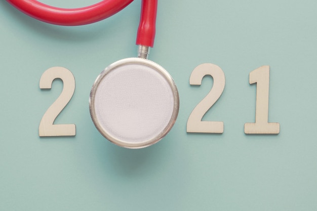 2021 wooden number with red stethoscope. Happy New Year health resolutions