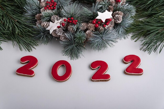 2022 inscription and Christmas wreath, top view. White background. Happy New Year 2022