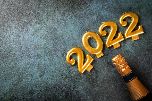 2022 numbers with champagne bottle and decor. Happy new year and festive concept. Top horizontal view copyspace. New Year Flatly. Christmas flatlay. New year 2022. New year concept.