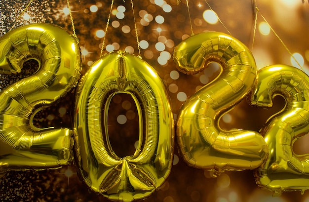 2022 written golden sign with a background in brown bokeh