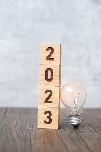 2023 block with lightbulb Business Idea Creative Thinking brainstorm Goal Resolution strategy plan Action change and New Year start concepts