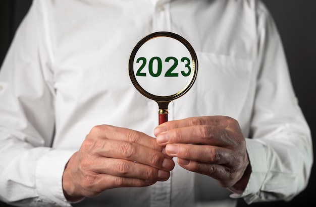 2023 business year analysis through magnifying glass lens magnifier