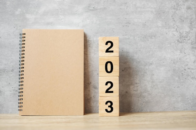 2023 Happy New Year with blank notebook and wooden number countdown Resolution Goals Plan Action and Mission Concept