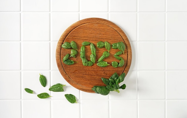 2023 made of spinach leaf on a wooden cutting board health and healthy lifestyle resolutions vegan Happy New Year