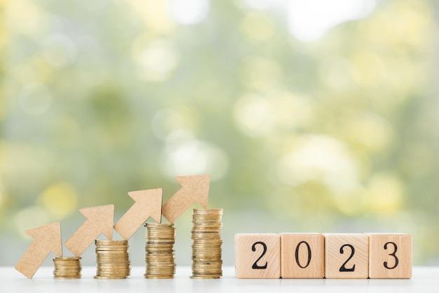 2023 New year on coins stack for saving money and financial planning concept