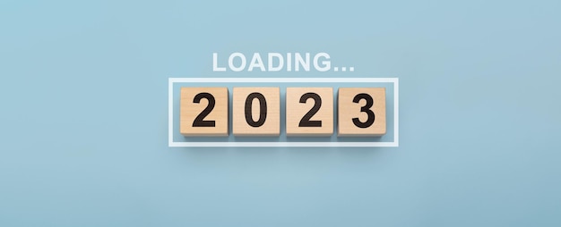 2023 New Year Loading Loading bar with wooden blocks 2023 on blue background Start new year 2023 with goal plan goal concept action plan strategy new year business vision