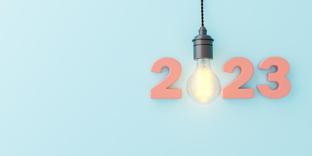 2023 sign with glowing lamp hanging on blue background