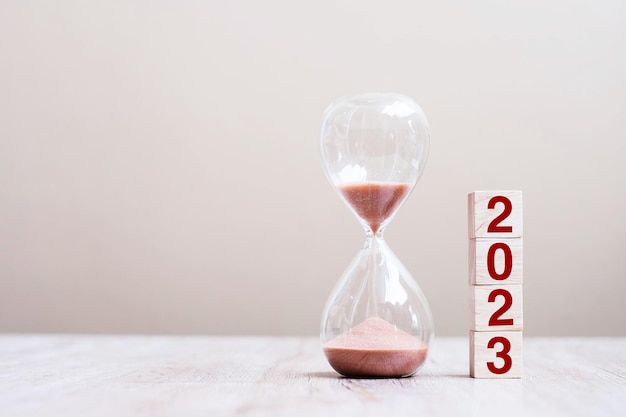 2023 text with hourglass on table Resolution time plan goal motivation reboot countdown and New Year holiday concepts