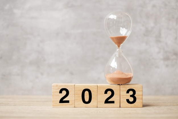 2023 text with hourglass on table Resolution time plan goal motivation reboot countdown and New Year holiday concepts