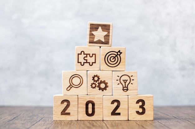 2023 wood block with business success goal strategy target mission action objective teamwork plan idea and New Year start concept