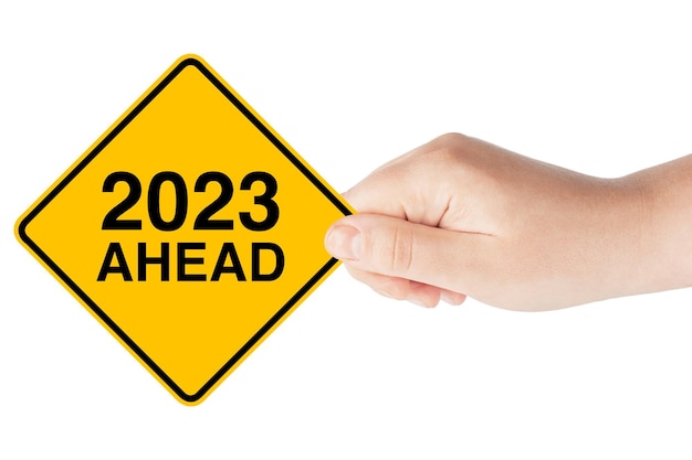 2023 Year Ahead Traffic Sign in Woman's Hand