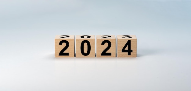 2024 New Year Wooden blocks 2024 on neutral grey background 2023 to 2024 on wooden block cube for preparation new year change and start new business target strategy concept