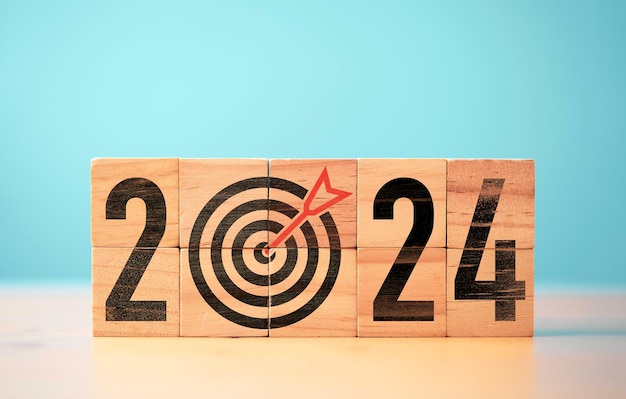 2024 year with dartboard and arrow on wooden block cube for setup new business objective target and goal since new year concept Happy new year and merry Christmas concept