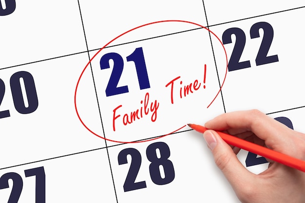 21st day of the month Hand writing text FAMILY TIME and circling the calendar date