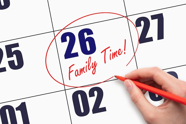 26th day of the month Hand writing text FAMILY TIME and circling the calendar date