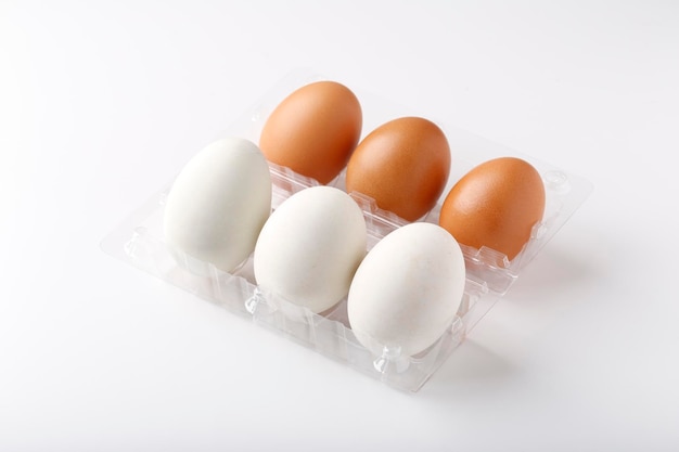 3 Duck eggs White color and 3 chicken eggs Brown color arranged in plastic packaging boxes for sale