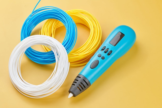 3d pen for creating volume plastic figures isolated on yellow background