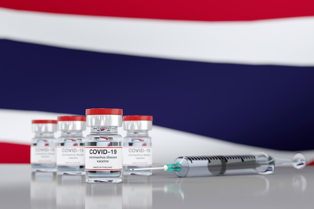 3D rendering a Concept of coronavirus vaccine made in Thailand with vaccine vial and syringe with Thai flag background.