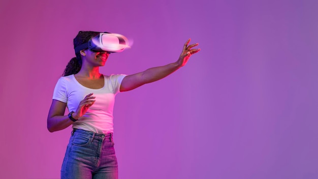 3D Simulation Young black female in glowing vr glasses playing online game