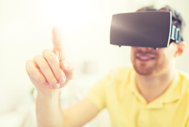 Photo 3d technology virtual reality entertainment and people concept close up of happy young man with virtual reality headset or 3d glasses playing game at home