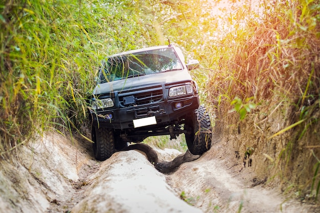 4 wheel drive is climbing on a difficult off-road in mountain forests in Thailand.